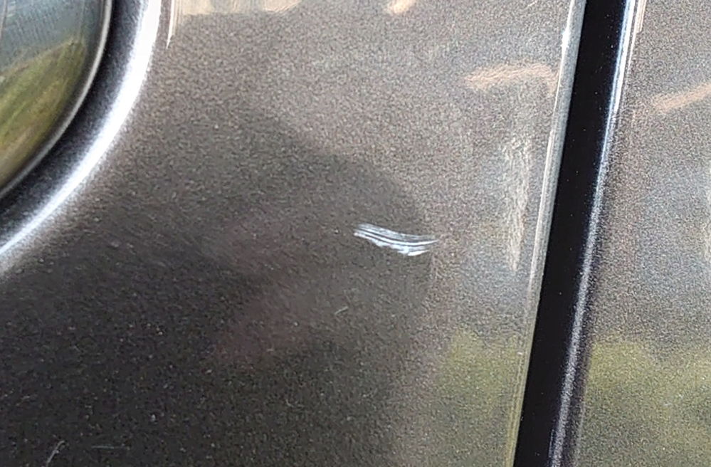 車の傷について教えてください。 画像の傷は下地が見えてしまっているのでしょうか？ また、このような傷は放置すると錆びてしまいますか？
