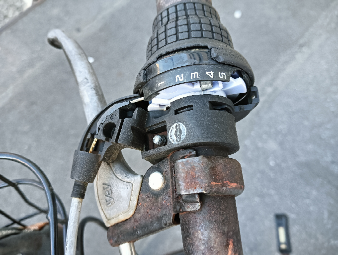 自転車のギアについて質問させて下さい。 写真のギアの黒いグリップ部分を握って、回転させようとしても一切動きません。 ギアの仕組みがよくわかっていないのですが、何か原因の見当はつきますでしょうか？ もらった自転車でギアが動かなくなった原因は不明です。 ※質問が要領を得ず、すいません。ギアチェンジできなくても問題なく乗れるので、簡単に直ったらラッキーぐらいで質問しております